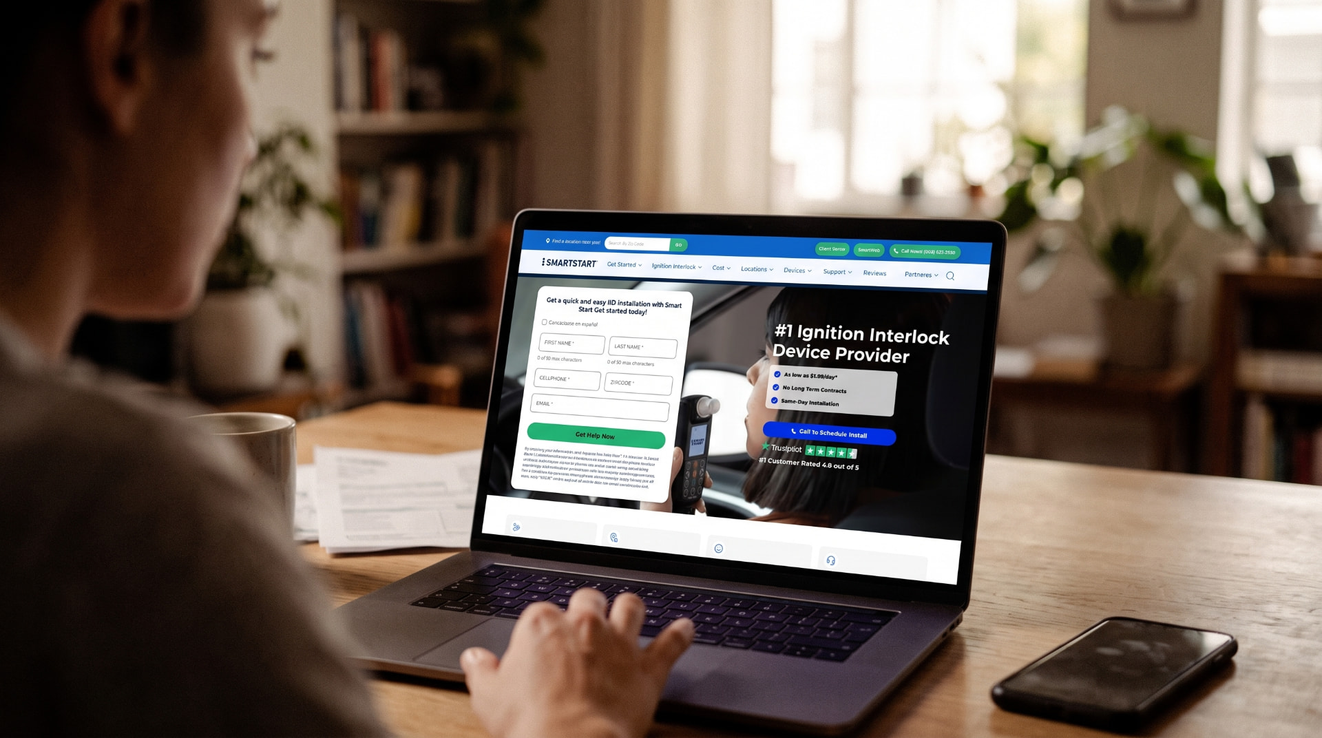 Smart Start website open on a laptop at a wooden desk